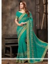 Adorable Sea Green Patch Border Work Faux Georgette Designer Saree